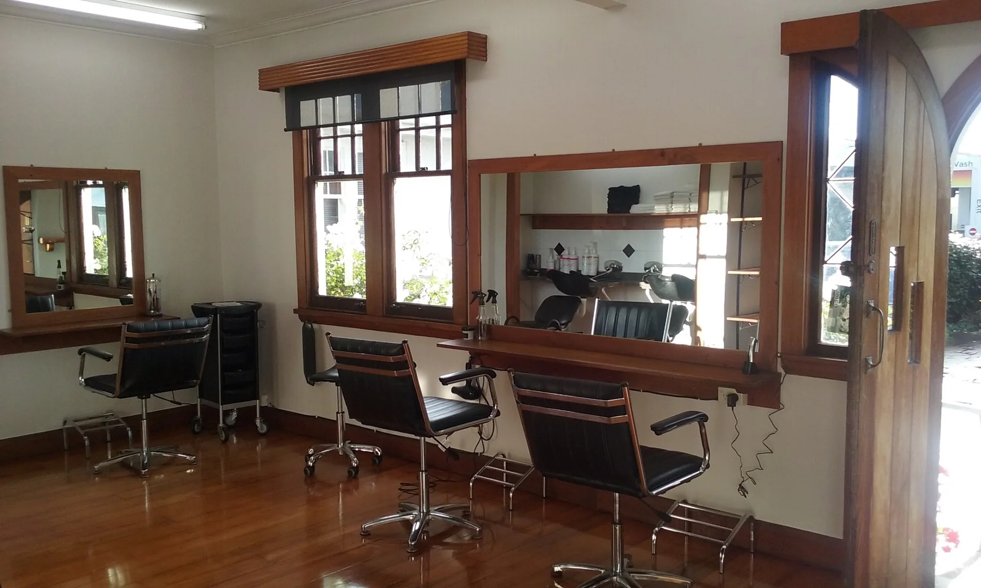 Inside the salon: styling chairs and wooden-framed mirrors