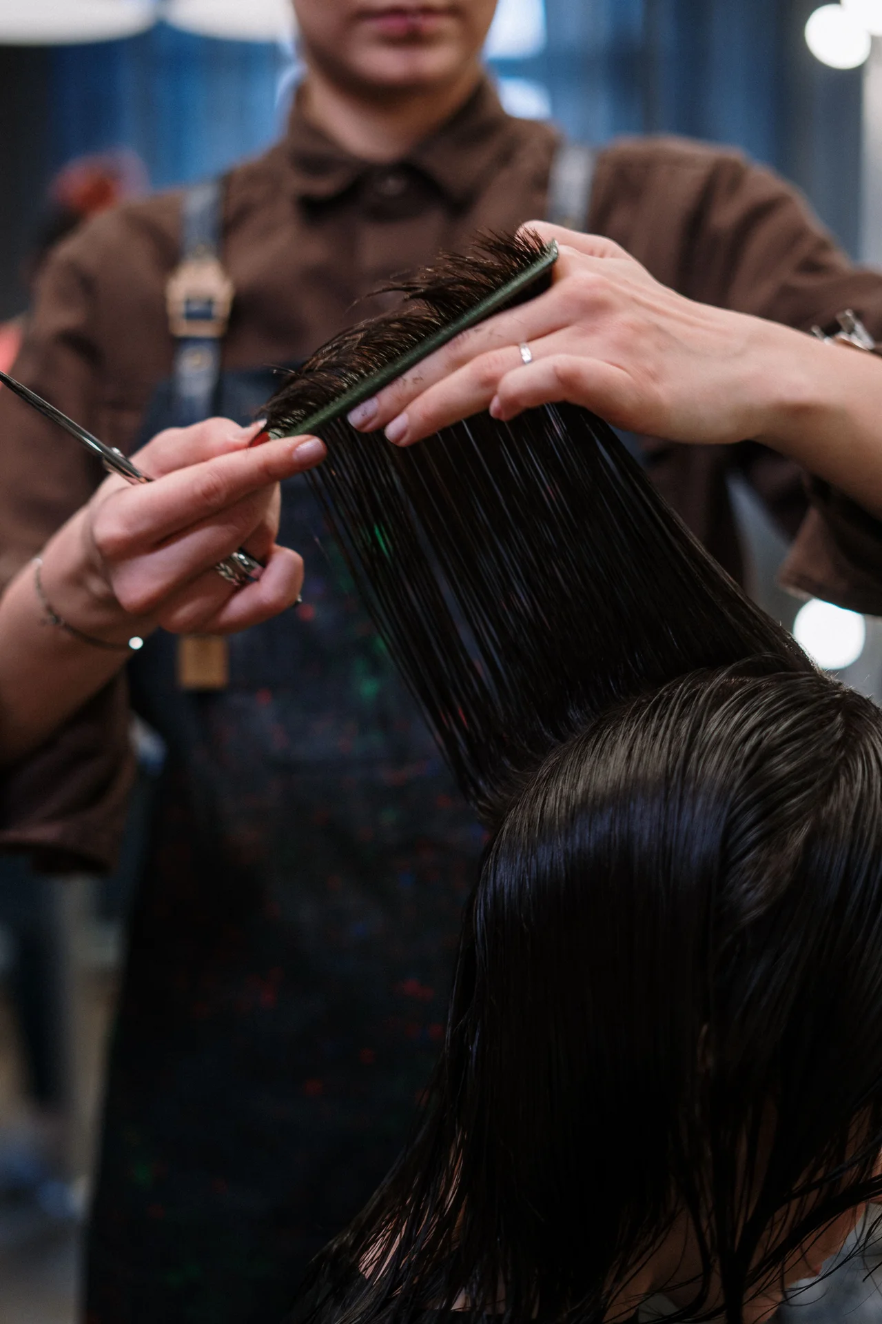 A stylist cutting wet hair