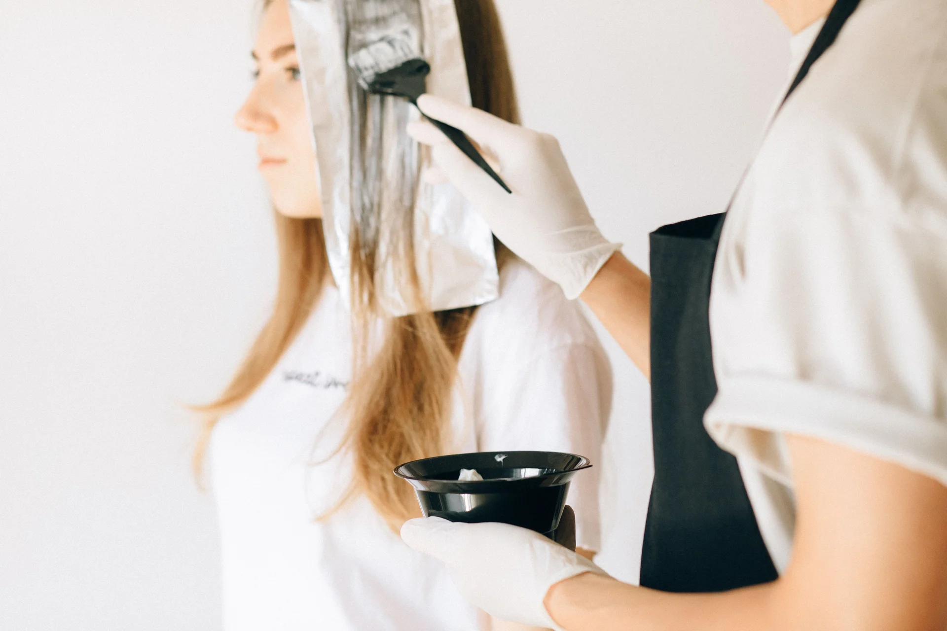 Foils being applied to a client's hair